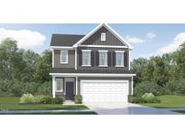 Charming two-story home featuring gray siding, a two-car garage, and manicured landscaping for curb appeal at 529 Morning Light Dr, Angier, NC 27501