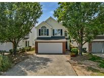 Charming two-story home featuring a two-car garage, landscaped yard, and classic architectural details at 5456 Grand Traverse Dr, Raleigh, NC 27604