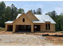 Unfinished exterior of a single-story home with a two-car garage and a gabled roof under construction at 63 W Victoria Ridge Dr # 31, Selma, NC 27576