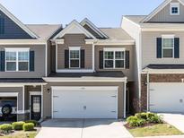 Charming townhome with a two-car garage and inviting curb appeal at 6341 Grace Lily Dr, Raleigh, NC 27607