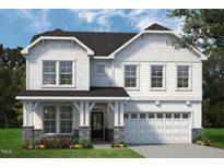 New two-story home boasts stone accents, a covered front porch, and an attached two-car garage at 680 Beacon Hill Rd # 52, Lillington, NC 27546