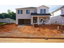New two-story home showcasing gray siding, a two-car garage, and construction in progress on the front yard at 737 Deschutes Dr, Garner, NC 27529