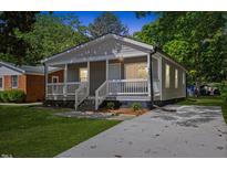 Charming gray home with a welcoming front porch and well-maintained lawn at 806 Martin Luther King Jr Dr, Smithfield, NC 27577