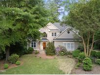 Charming two-story home with brick accents, complemented by lush landscaping and mature trees at 927 Jones Wynd, Wake Forest, NC 27587