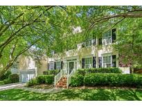Charming two-story home with a manicured lawn, lush landscaping, and inviting entrance at 1204 Caribou Xing, Durham, NC 27713