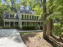 Charming two-story home with a welcoming front porch and lush greenery at 128 Cobblestone Dr, Chapel Hill, NC 27516