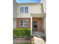 Inviting townhome entrance with brick facade, well-kept landscaping, and a bright, welcoming exterior at 1610 Oxleymare Dr, Raleigh, NC 27610