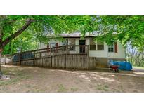 Charming single-story home featuring a ramp for accessibility and surrounded by lush greenery and mature trees at 1701 Sunset St, Roxboro, NC 27573