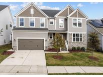 Charming two-story home featuring a mix of siding and stone accents, a two-car garage, and a well-manicured front yard at 1816 Sandoval Dr, Durham, NC 27703