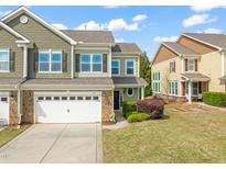 Two-story home with a two-car garage, beautiful stone accents, and well-maintained landscaping at 201 Mayfield Dr, Apex, NC 27539