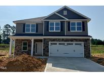 Two-story home featuring stone accents, gray siding, black shutters, and a spacious two-car garage at 606 Melrose Ct, Sanford, NC 27330