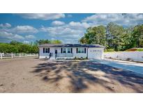 Charming, renovated ranch home featuring a fresh white paint job and new landscaping at 6715 Princeton Kenly Rd, Princeton, NC 27569
