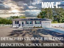 Charming, move-in-ready single-story home featuring a detached two-car garage and a well-maintained, landscaped yard at 6715 Princeton Kenly Rd, Princeton, NC 27569