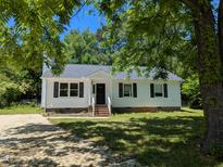 Charming single-story home featuring a white exterior, black shutters, and a well-maintained front yard at 710 E Azalea Ct, Fuquay Varina, NC 27526