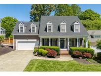 Charming two-story home with a well-manicured lawn, attached garage, and welcoming front porch at 10320 Crisp Dr, Raleigh, NC 27614