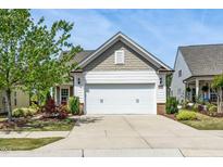 Charming home featuring a two-car garage, beautiful landscaping, and inviting curb appeal at 112 Manning Way, Durham, NC 27703