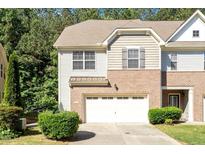 Charming brick and siding townhome with an attached garage and manicured landscaping at 1175 Contessa Dr, Cary, NC 27513