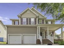 Charming two-story home with a welcoming front porch, attached two-car garage, and traditional siding details at 133 Pasadena Rd, Garner, NC 27529