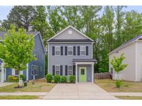 Charming two-story home with a well-manicured lawn, a bright green door, and a concrete driveway at 138 Yellow Jacket Rdg, Clayton, NC 27520