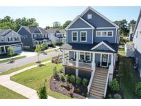 Charming two-story home with a welcoming front porch and beautifully landscaped yard in a desirable neighborhood at 201 Annabelle Blue Drive, Wake Forest, NC 27587