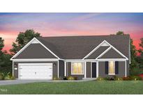 Charming single-story home featuring gray siding, white trim, and a well-manicured lawn at 2420 Del Webb Gardens Dr, Fuquay Varina, NC 27526