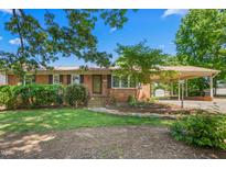 Charming single-story brick home with a well-maintained lawn and covered parking, offering classic curb appeal at 2917 Trail Six, Burlington, NC 27215
