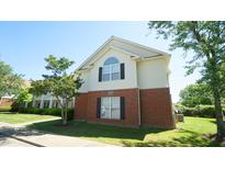 Two-story building with white siding, brick facade, green grass, and black shuttered windows at 4024 Claret Ln, Morrisville, NC 27560