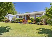 Charming single-story home featuring a beautifully landscaped front yard and welcoming front porch at 416 Mitchell St, Hillsborough, NC 27278