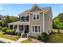 Charming two-story home with a welcoming front porch and well-maintained landscaping at 508 Vervain Way, Holly Springs, NC 27540