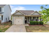 Charming single-story home with a well-manicured lawn and inviting covered front porch at 51 Balboa Parkway Pkwy, Clayton, NC 27520