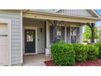 Charming covered porch with decorative posts, shutters and a welcoming front door with a 'Welcome' sign at 51 Balboa Pkwy, Clayton, NC 27520