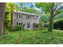 Charming two-story home featuring a brick chimney and well-maintained landscaping at 5212 Badham Pl, Raleigh, NC 27609