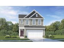 Charming two-story home with a classic design and manicured lawn and a two car garage at 545 Morning Light Dr, Angier, NC 27501