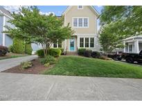 Charming two-story home featuring a well-manicured lawn and a vibrant turquoise front door at 707 Sasser St, Raleigh, NC 27604