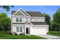 Charming two-story home with covered entrance, attached two-car garage, and beautifully landscaped front yard at 776 Old Station Pointe, Angier, NC 27501