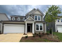 Charming two-story home with attached garage and landscaped front yard at 776 Old Station Pointe, Angier, NC 27501