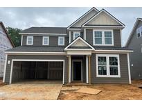 New two-story home featuring a two-car garage and classic design with gray siding and white trim at 776 Old Station Pointe, Angier, NC 27501