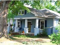 Charming blue two-story home featuring a covered front porch with white columns and manicured landscaping at 1013 Green St, Durham, NC 27701