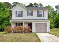 Two-story home with beige siding, purple shutters, one-car garage, and lush landscaping at 1743 Longshadow Dr, Burlington, NC 27217