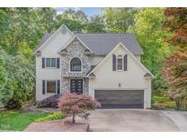 Charming two-story home with stone accents, attached two-car garage, and beautiful landscaping at 208 W Camden Forest Dr, Cary, NC 27518