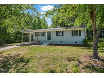 Charming single-story home featuring a covered front porch and well-maintained landscaping at 2108 Laurel Mill Centerville Rd, Louisburg, NC 27549