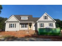 Charming single-Gathering home with gray siding, black shutters and a nicely framed front door at 499 Mulberry Rd, Spring Hope, NC 27882