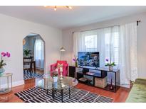 Bright living room featuring hardwood floors, natural light, modern décor, and decorative black and white area rug at 508 E Trinity Ave, Durham, NC 27701