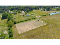 Expansive aerial view showcases acreage, pond, and serene homesites in a rural community at 5423 Nc-39, Selma, NC 27576