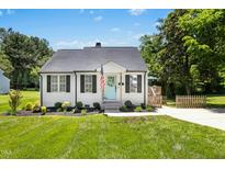 Charming one-story home with a well-manicured lawn and a delightful light-blue front door at 624 Wait Ave, Wake Forest, NC 27587