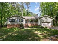 Charming single-story home with a brick foundation, well-maintained lawn, and a two-car garage at 7200 Rabbit Run, Wake Forest, NC 27587