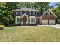 Charming brick home with a well-manicured lawn and lush landscaping at 108 Westport Dr, Cary, NC 27511