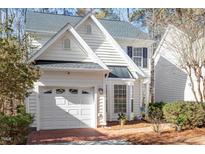 Charming two-story home features a white exterior, attached garage and beautifully landscaped front yard at 1208 Copper Creek Dr, Durham, NC 27713
