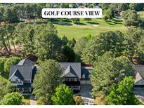 Stunning home with golf course views surrounded by lush greenery and mature trees at 1401 Marshall Farm St, Wake Forest, NC 27587