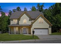 Charming two-story home featuring a two-car garage, landscaped lawn, and a welcoming front porch at 1605 Sassafras St, Durham, NC 27712